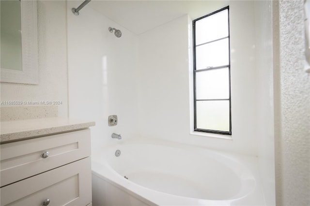 bathroom with washtub / shower combination and vanity