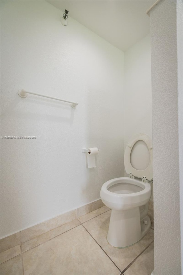 bathroom featuring tile patterned flooring and toilet