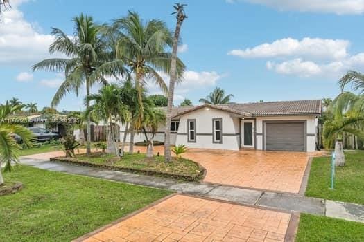 view of front of home featuring a garage and a front lawn