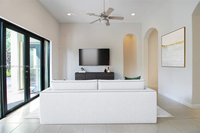 tiled living room featuring ceiling fan