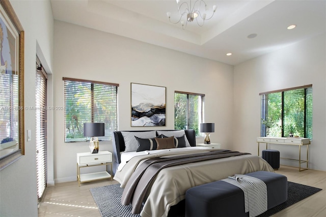 bedroom with multiple windows and an inviting chandelier