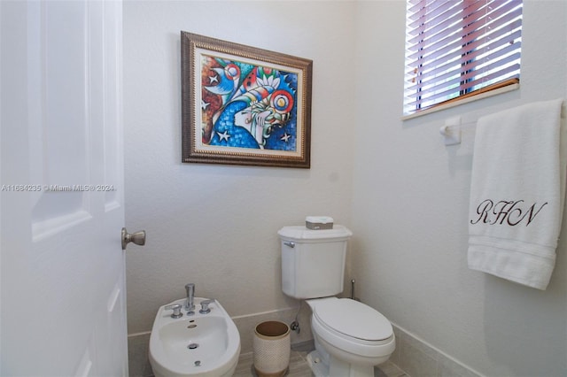 bathroom featuring toilet and a bidet