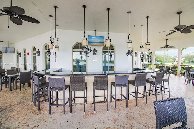 kitchen with pendant lighting, a breakfast bar, and ceiling fan