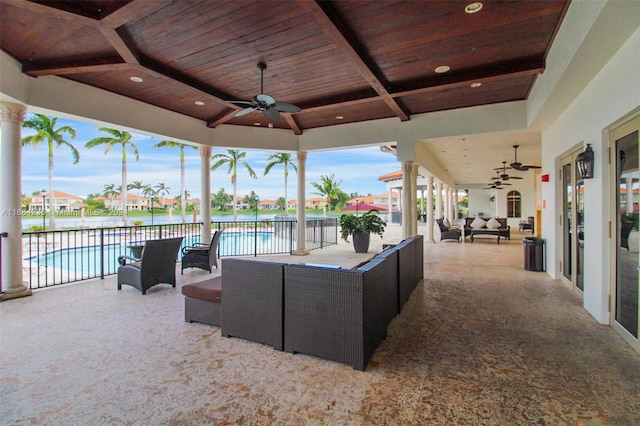 view of patio featuring outdoor lounge area, a water view, and ceiling fan