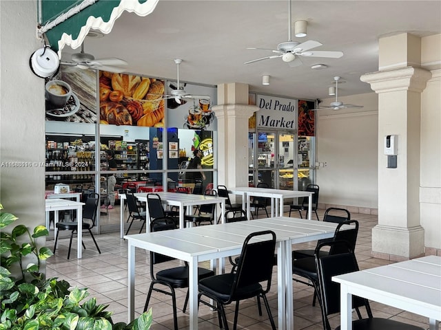 tiled dining space with ornate columns and ceiling fan