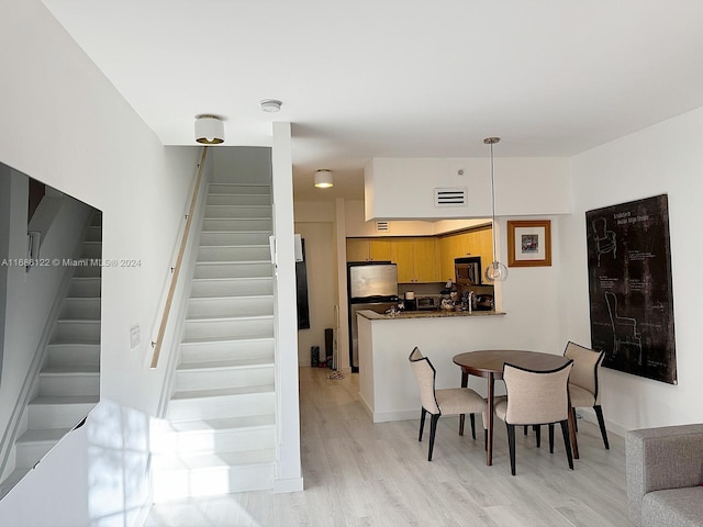 dining space featuring light wood-type flooring