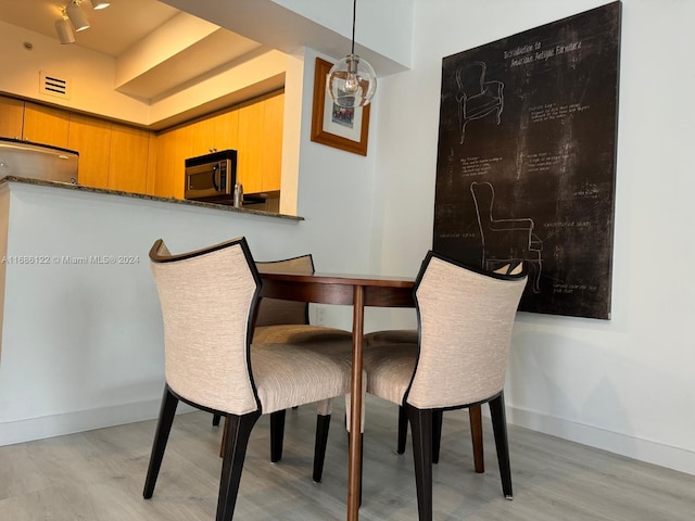 dining space featuring light hardwood / wood-style floors