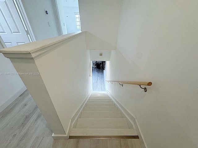 stairway featuring hardwood / wood-style flooring