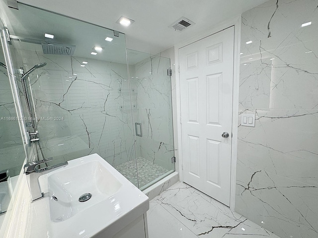 bathroom featuring vanity and an enclosed shower