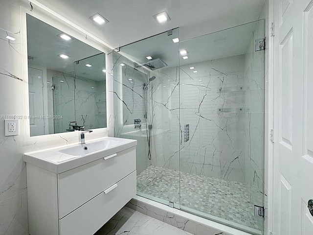 bathroom featuring vanity and an enclosed shower