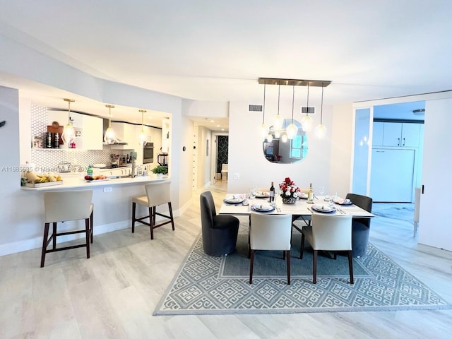 dining space with light wood-type flooring