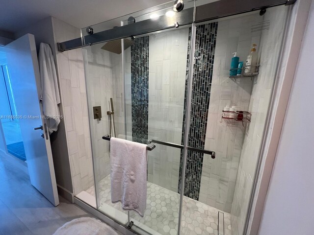 bedroom featuring light wood-type flooring and ensuite bath