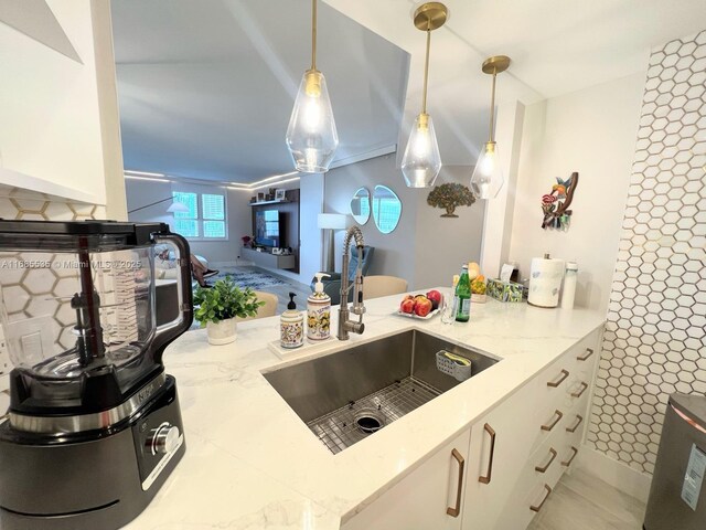 kitchen with wall chimney exhaust hood, light wood-type flooring, white cabinetry, appliances with stainless steel finishes, and tasteful backsplash