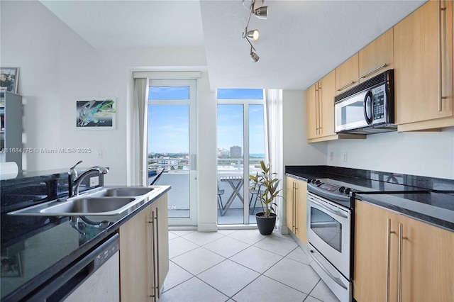 kitchen featuring light tile patterned flooring, dishwasher, sink, light brown cabinets, and electric stove