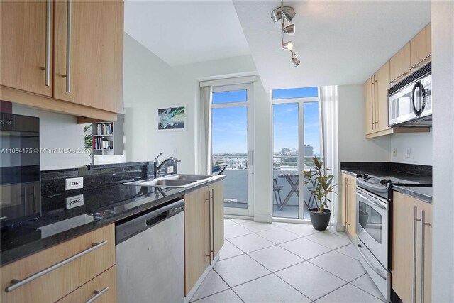 kitchen featuring sink, light tile patterned flooring, and stainless steel appliances