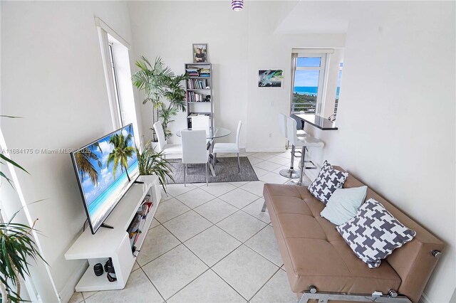 living room featuring light tile patterned flooring and a healthy amount of sunlight