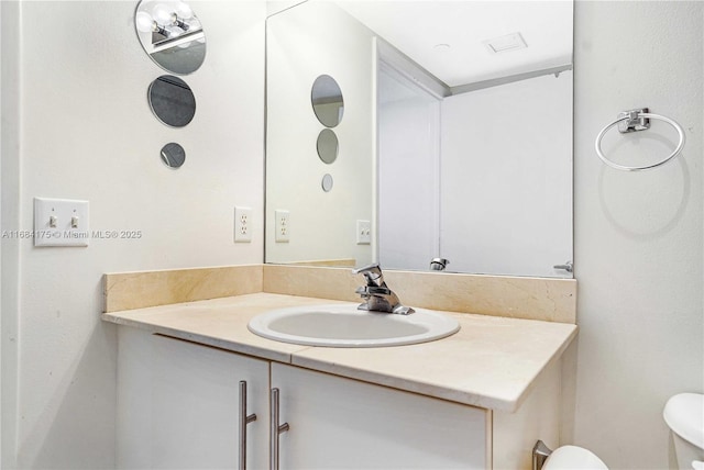 bathroom featuring vanity and toilet