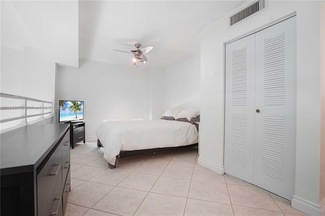 tiled bedroom with a closet and ceiling fan