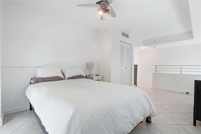 tiled bedroom featuring a closet and ceiling fan