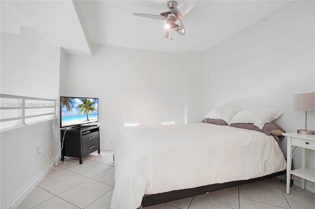 tiled bedroom featuring ceiling fan