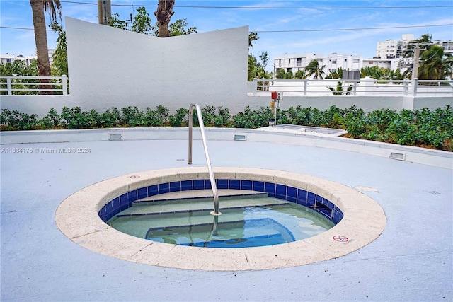 view of swimming pool featuring a community hot tub