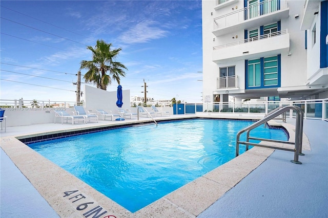 view of swimming pool with a patio area