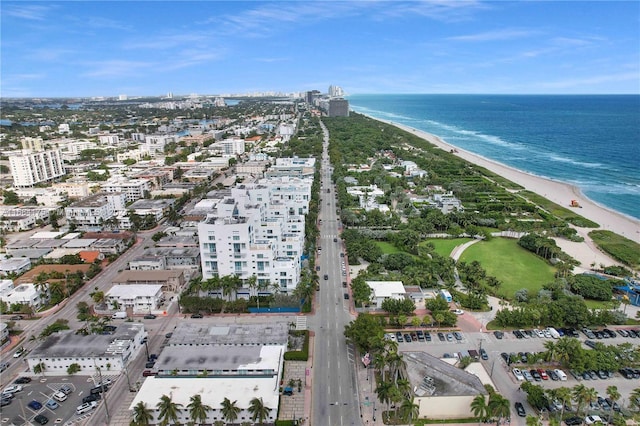 bird's eye view featuring a water view and a beach view