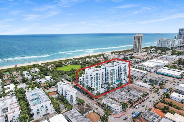 bird's eye view with a water view and a view of the beach