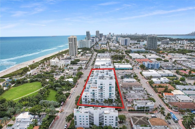 drone / aerial view featuring a view of the beach and a water view