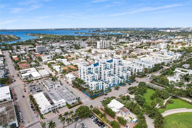 birds eye view of property featuring a water view and a beach view