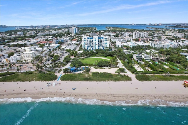 drone / aerial view featuring a water view and a view of the beach