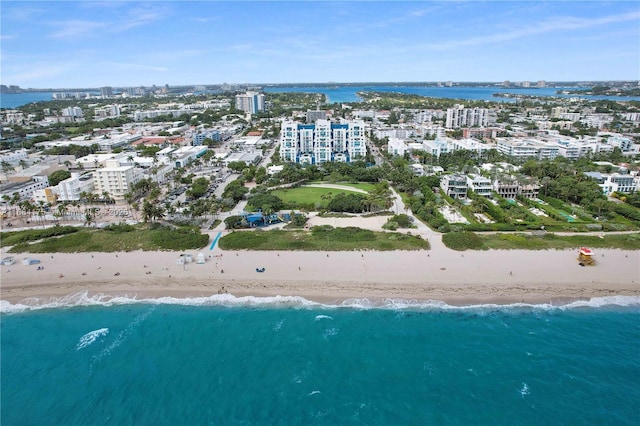 birds eye view of property with a water view and a view of the beach