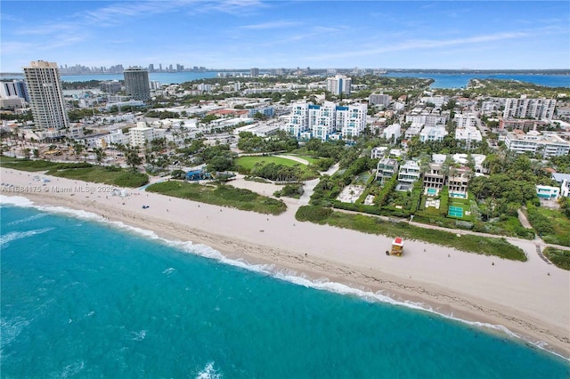 birds eye view of property featuring a water view and a view of the beach