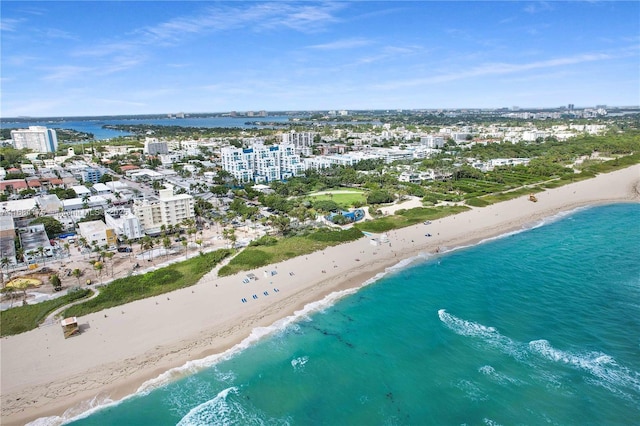 drone / aerial view featuring a water view and a view of the beach