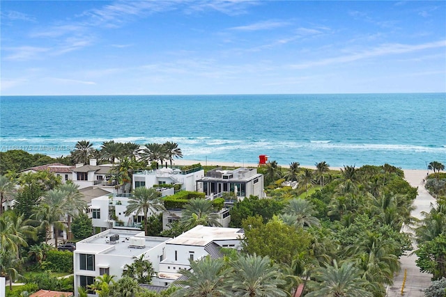 birds eye view of property with a water view and a view of the beach