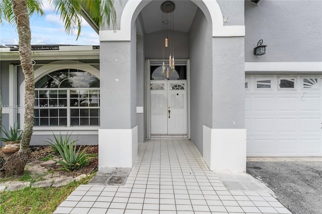 view of exterior entry featuring a garage