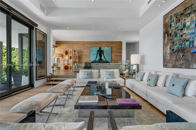 living room featuring wood walls and light wood-type flooring