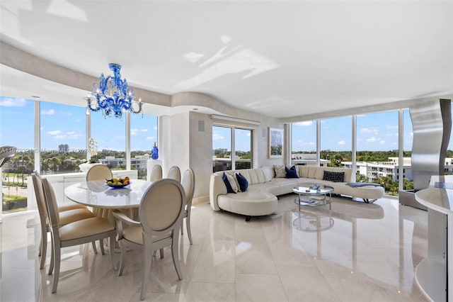 sunroom / solarium with a notable chandelier