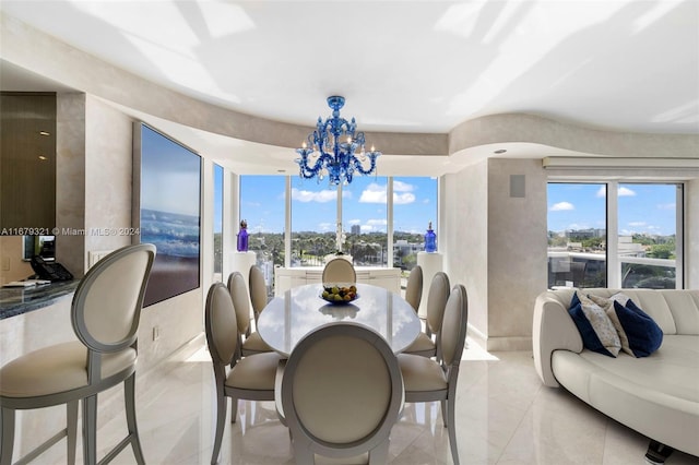 dining space with light tile patterned floors and a chandelier