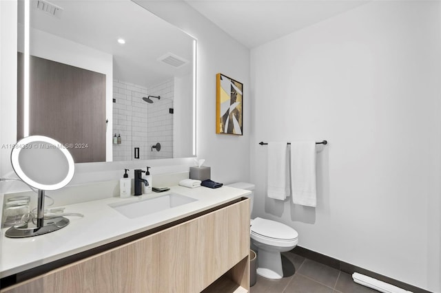 bathroom featuring vanity, toilet, tile patterned flooring, and an enclosed shower