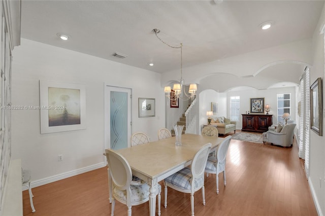 dining room with a chandelier and light hardwood / wood-style floors