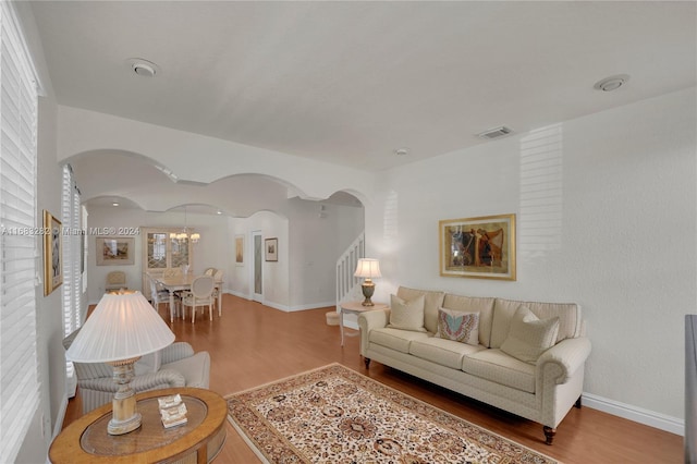 living room featuring hardwood / wood-style floors and a notable chandelier