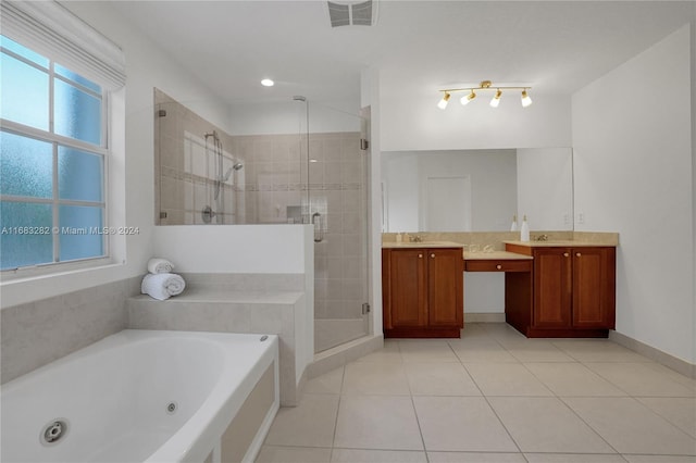 bathroom with plus walk in shower, vanity, and tile patterned flooring