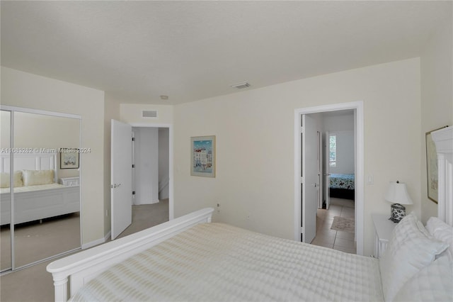 bedroom with light tile patterned flooring and a closet