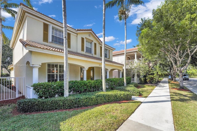 mediterranean / spanish home featuring a front yard