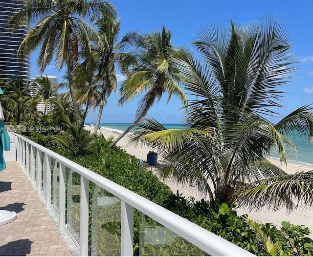 balcony with a water view and a beach view