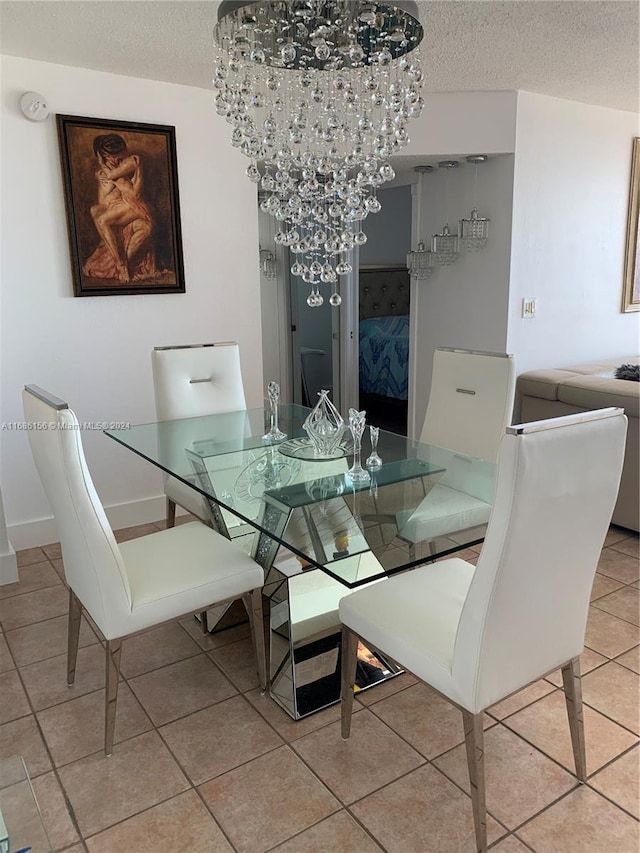 tiled dining room featuring a notable chandelier and a textured ceiling