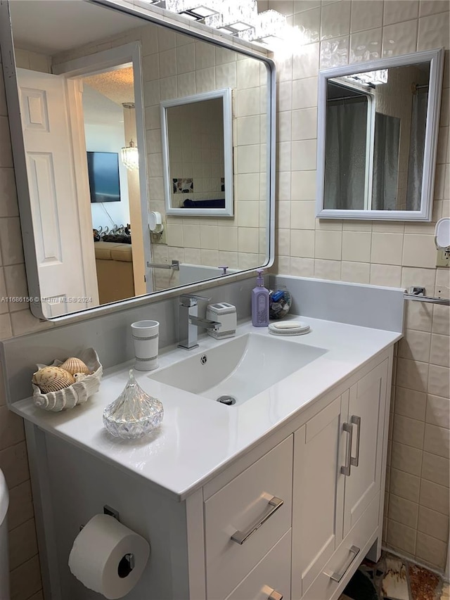 bathroom with vanity and tile walls