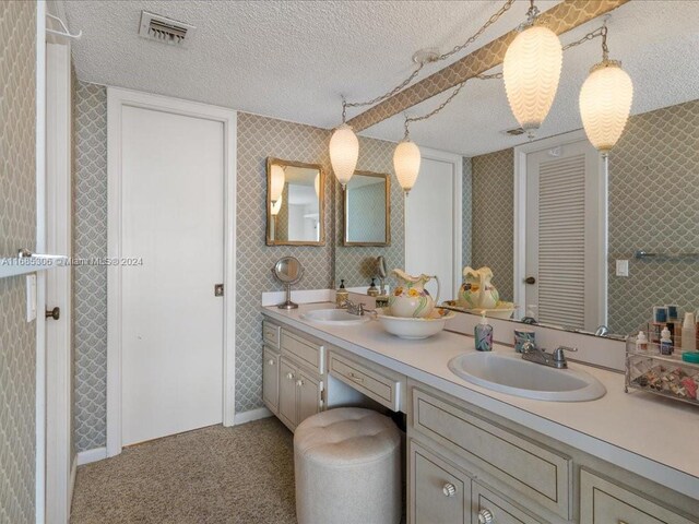 bathroom featuring vanity and a textured ceiling