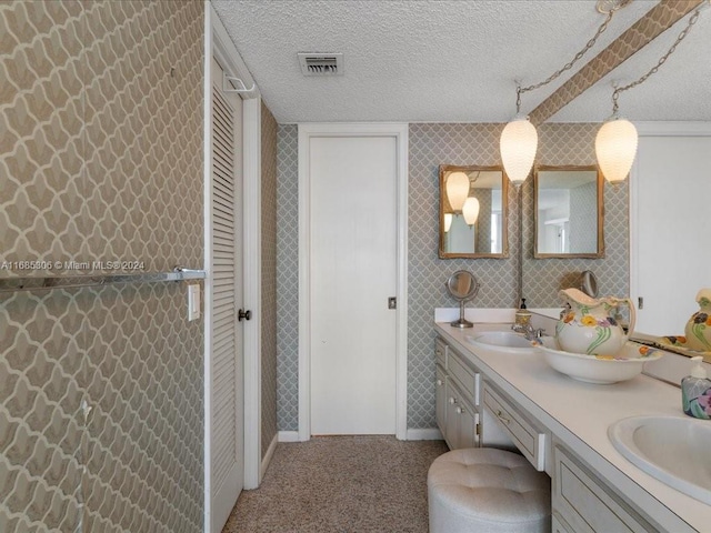 bathroom with vanity and a textured ceiling